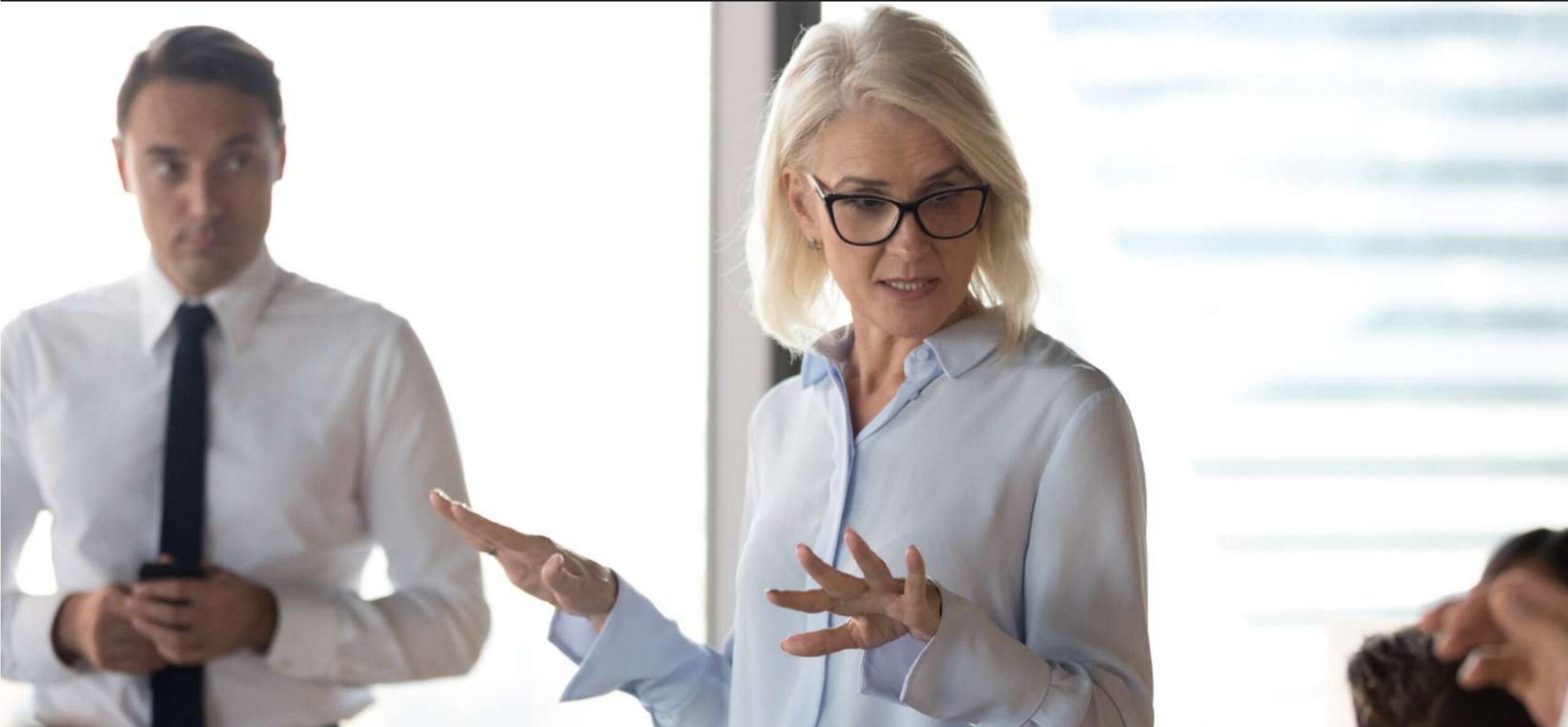 An executive coaching conversation in a corporate meeting room